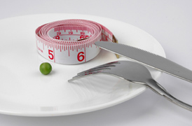 Pea and measuring tape on a plate